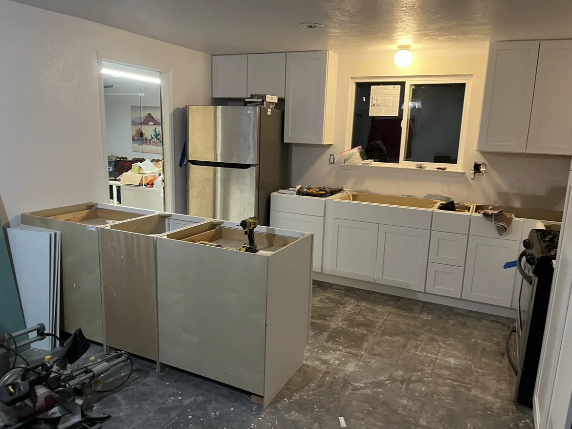White cabinets installed before the countertops.