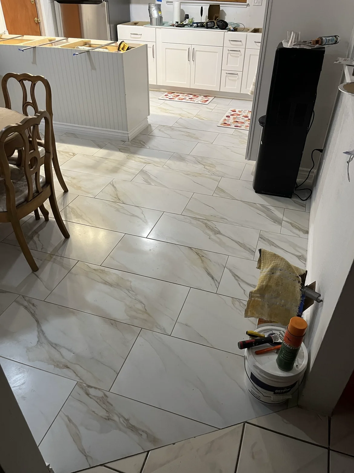 Tile flooring connecting the kitchen and dining area