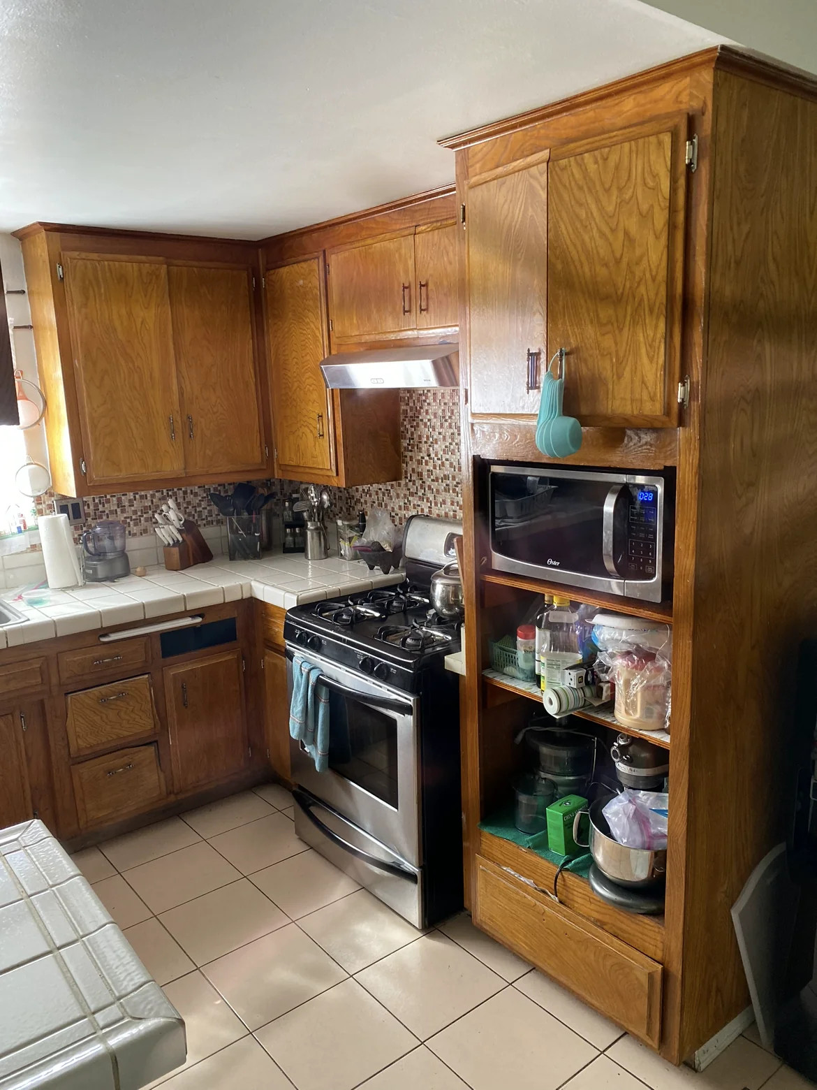 Original wood cabinetry and tiled counters.